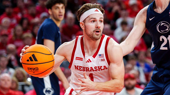 Nebraska Cornhuskers guard Sam Hoiberg drives against Penn State Nittany Lions forward Justin Houser. Nebraska Cornhuskers guard Sam Hoiberg drives against Penn State Nittany Lions forward Justin Houser.