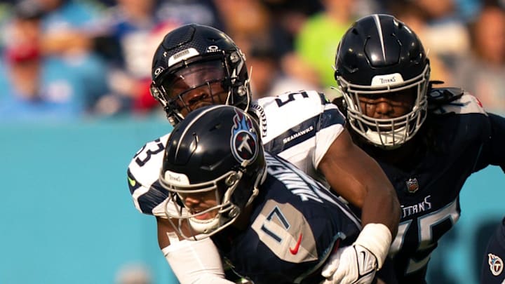 Seattle Seahawks linebacker Boye Mafe (53) brings down Tennessee Titans quarterback Ryan Tannehill