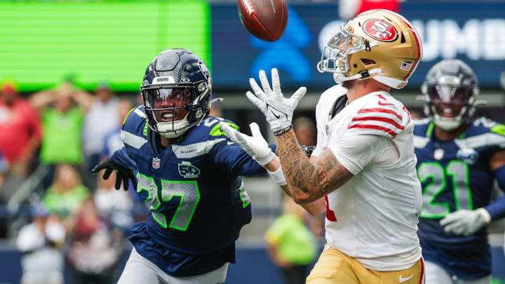 Sep 7, 2025; Seattle, Washington, USA; San Francisco 49ers wide receiver Ricky Pearsall (1) catches a pass against Seattle Seahawks cornerback Riq Woolen (27) during the fourth quarter at Lumen Field. 