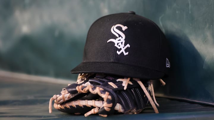 Jul 14, 2023; Atlanta, Georgia, USA; A detailed view of a Chicago White Sox hat and glove in the dugout against the Atlanta Braves in the fourth inning at Truist Park. Mandatory Credit: Brett Davis-Imagn Images