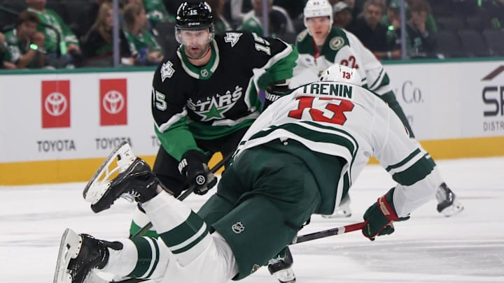 Apr 18, 2026; Dallas, Texas, USA;Minnesota Wild center Yakov Trenin (13) is tripped while skating with the puck against Dallas Stars center Colin Blackwell (15) in the third period in game one of the first round of the 2026 Stanley Cup Playoffs at American Airlines Center. Mandatory Credit: Thomas Shea-Imagn Images