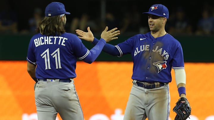 Toronto Blue Jays shortstop Bo Bichette (left) and second baseman Whit Merrifield (right) high-five Toronto Blue Jays shortstop Bo Bichette (left) and second baseman Whit Merrifield (right) high-five