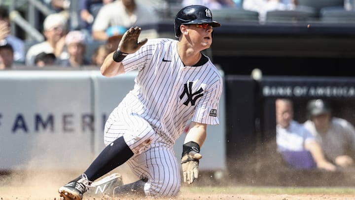 Aug 25, 2024; Bronx, New York, USA;  New York Yankees first baseman DJ LeMahieu (26) slides safely at home plate in the second inning against the Colorado Rockies at Yankee Stadium. Mandatory Credit: Wendell Cruz-Imagn Images