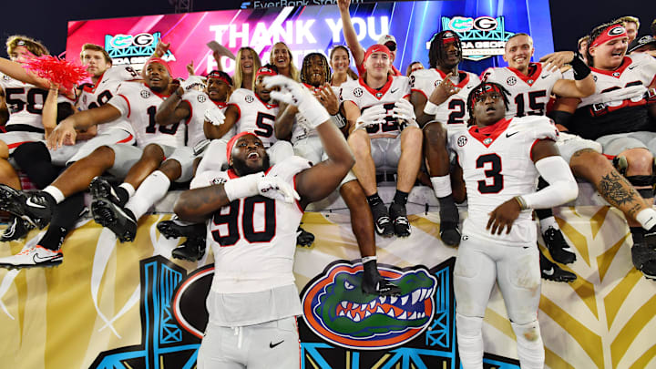 Georgia players celebrate in the stands with fans after their victory over the Florida Gators Saturday night. The annual Florida vs Georgia football game at EverBank Stadium in Jacksonville, FL, Saturday, October 27, 2023. Georgia walked away with a final score of 43 to 20. [Bob Self/Florida Times-Union]