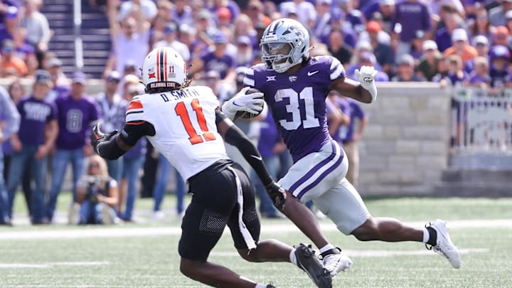 Sep 28, 2024; Manhattan, Kansas, USA; Kansas State Wildcats running back DJ Giddens (31) runs the ball against Oklahoma State Cowboys safety Dylan Smith (11) during the third quarter at Bill Snyder Family Football Stadium. Mandatory Credit: Scott Sewell-Imagn Images Sep 28, 2024; Manhattan, Kansas, USA; Kansas State Wildcats running back DJ Giddens (31) runs the ball against Oklahoma State Cowboys safety Dylan Smith (11) during the third quarter at Bill Snyder Family Football Stadium. Mandatory Credit: Scott Sewell-Imagn Images