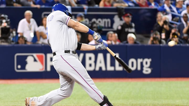 Oct 9, 2016; Toronto, Ontario, CAN; Texas Rangers first baseman Mitch Moreland hits a two-run double against the Toronto Blue Jays in the 6th inning during game three of the 2016 ALDS playoff baseball series at Rogers Centre. 