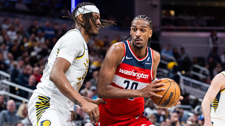 Apr 8, 2025; Indianapolis, Indiana, USA; Washington Wizards forward Alex Sarr (20) dribbles the ball while Indiana Pacers center Myles Turner (33)  defends in the second half at Gainbridge Fieldhouse. Mandatory Credit: Trevor Ruszkowski-Imagn Images