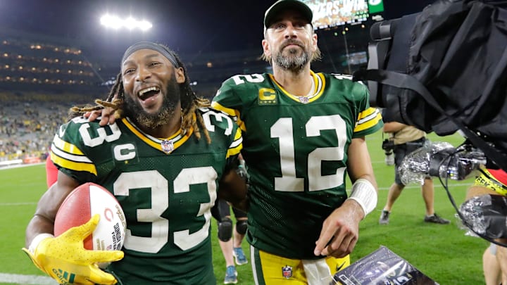 Former Green Bay Packers running back Aaron Jones (33) and quarterback Aaron Rodgers (12) walk off the field arm in arm after defeating the Chicago Bears during their football game Sunday, September 18, 2022, at Lambeau Field in Green Bay, Wis.