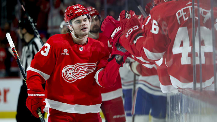 Apr 15, 2024; Detroit, Michigan, USA;  Detroit Red Wings right wing Alex DeBrincat (93) receives congratulations from teammates after scoring in the third period against the Montreal Canadiens at Little Caesars Arena. Mandatory Credit: Rick Osentoski-USA TODAY Sports