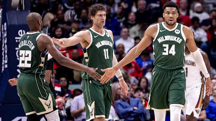 Mar 28, 2024; New Orleans, Louisiana, USA;  Milwaukee Bucks forward Giannis Antetokounmpo (34) slaps hands with forward Khris Middleton (22) and center Brook Lopez (11) after a play against the New Orleans Pelicans during the second half at Smoothie King Center. Mandatory Credit: Stephen Lew-Imagn Images