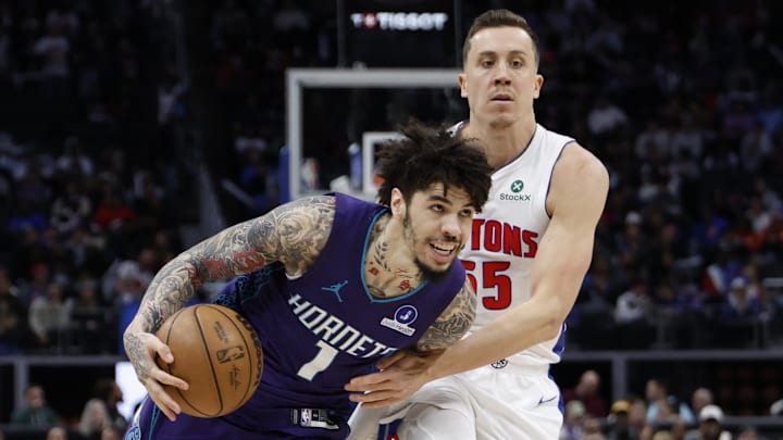 Dec 20, 2025; Detroit, Michigan, USA;  Charlotte Hornets guard Lamelo Ball (1) dribbles defended by Detroit Pistons forward Duncan Robinson (55) in the second half at Little Caesars Arena. Mandatory Credit: Rick Osentoski-Imagn Images