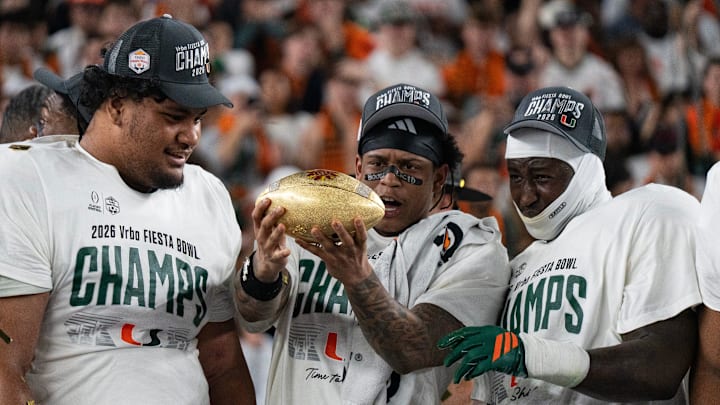 Miami Hurricanes players admire the trophy after winning the CFP Fiesta Bowl against Ole Miss at the State Farm Stadium, in Glendale, Ariz., on Thursday, Jan. 8, 2026. Miami Hurricanes players admire the trophy after winning the CFP Fiesta Bowl against Ole Miss at the State Farm Stadium, in Glendale, Ariz., on Thursday, Jan. 8, 2026.