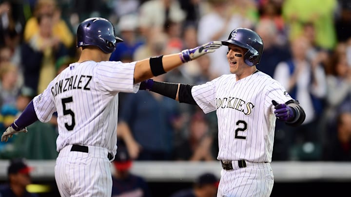 Jul 11, 2014; Denver, CO, USA; Colorado Rockies shortstop Troy Tulowitzki (2) reacts with Colorado Rockies left fielder Carlos Gonzalez (5) after his two run home run in the third inning against the Minnesota Twins at Coors Field.