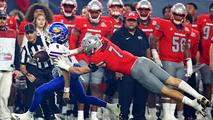 Kansas Jayhawks quarterback Jason Bean (9) runs the ball against UNLV Rebels linebacker Jackson Woodard (7) during the second quarter in the Guaranteed Rate Bowl at Chase Field.