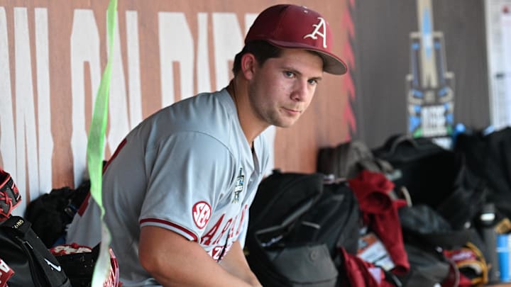 Jun 16, 2025; Omaha, Neb, USA;  Arkansas Razorbacks starting pitcher Gage Wood (14) waits in the dugout before the ninth inning against the Murray State Racers at Charles Schwab Field.