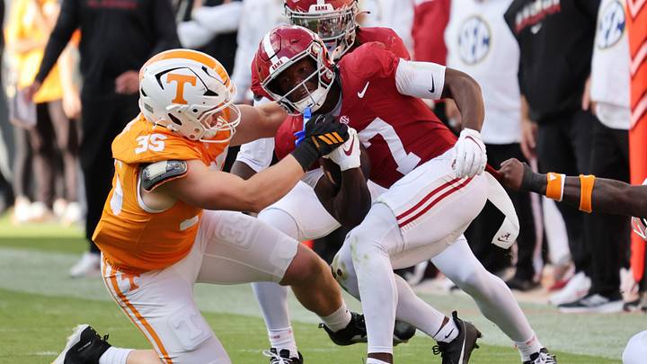 Oct 17, 2026; Knoxville, Tennessee, USA; Tennessee Volunteers defensive line Carson Gentle (35) tackles Alabama Crimson Tide wide receiver Rico Scott (7) during the first half at Neyland Stadium. Mandatory Credit: Randy Sartin-Imagn Images Oct 17, 2026; Knoxville, Tennessee, USA; Tennessee Volunteers defensive line Carson Gentle (35) tackles Alabama Crimson Tide wide receiver Rico Scott (7) during the first half at Neyland Stadium. Mandatory Credit: Randy Sartin-Imagn Images