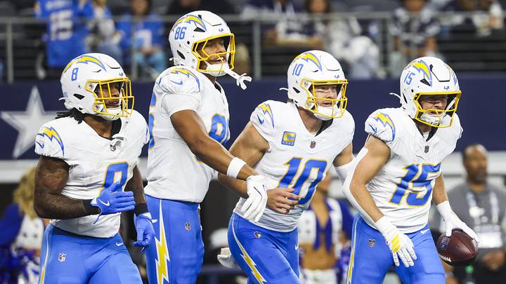 Dec 21, 2025; Arlington, Texas, USA; Los Angeles Chargers wide receiver Ladd McConkey runs back to the sideline with Omarion Hampton, Oronde Gadsden II and Justin Herbert after catching a touchdown pass from Herbert against the Dallas Cowboys during the second quarter at AT&T Stadium. Mandatory Credit: Kevin Jairaj-Imagn Images