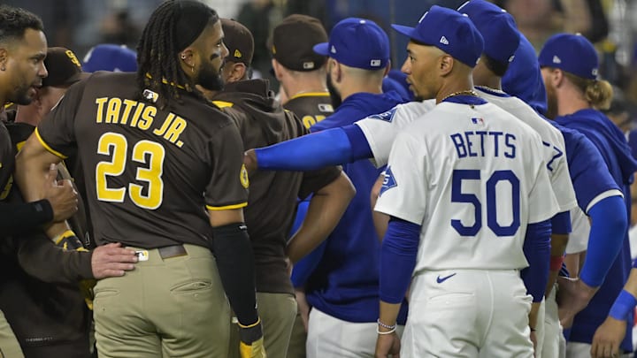 Jun 19, 2025; Los Angeles, California, USA;   San Diego Padres right fielder Fernando Tatis Jr. (23) and Los Angeles Dodgers shortstop Mookie Betts (50) engage on the field after benches cleared in the eighth inning at Dodger Stadium. Mandatory Credit: Jayne Kamin-Oncea-Imagn Images