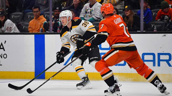 Mar 26, 2025; Anaheim, California, USA; Boston Bruins center Morgan Geekie (39) controls the puck against Anaheim Ducks defenseman Radko Gudas (7) during the third period at Honda Center. Mandatory Credit: Gary A. Vasquez-Imagn Images Mar 26, 2025; Anaheim, California, USA; Boston Bruins center Morgan Geekie (39) controls the puck against Anaheim Ducks defenseman Radko Gudas (7) during the third period at Honda Center. Mandatory Credit: Gary A. Vasquez-Imagn Images