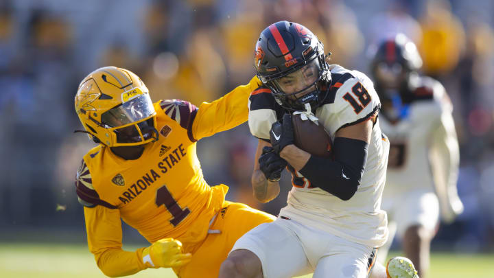 Nov 19, 2022; Tempe, Arizona, USA; Oregon State Beavers wide receiver Jeremiah Noga (18) makes a one handed catch against Arizona State Sun Devils defensive back Jordan Clark (1) during the second half at Sun Devil Stadium. Mandatory Credit: Mark J. Rebilas-USA TODAY Sports