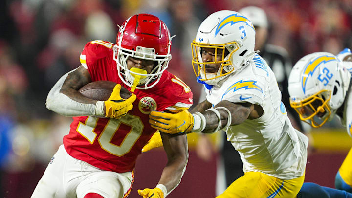 Dec 8, 2024; Kansas City, Missouri, USA; Kansas City Chiefs running back Isiah Pacheco (10) runs the ball against Los Angeles Chargers safety Derwin James Jr. (3) during the second half at GEHA Field at Arrowhead Stadium. 