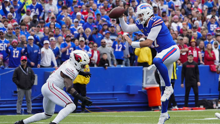Sep 8, 2024; Orchard Park, New York, USA; Buffalo Bills quarterback Josh Allen (17) leaps over Arizona Cardinals safety Budda Baker (3) into the end zone for a touchdown during the second half at Highmark Stadium. Mandatory Credit: Gregory Fisher-Imagn Images
