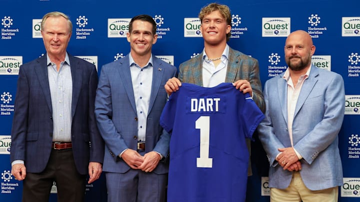 Apr 25, 2025; East Rutherford, NJ, US; New York Giants president John Mara (far left), general manager Joe Schoen (left), Jaxson Dart, and head coach Brian Daboll (right) pose for photos prior to the start of the press conference to introduce the Giants first round draft picks.  Mandatory Credit: Thomas Salus-Imagn Images