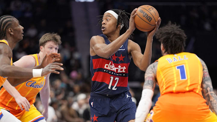 Jan 24, 2026; Charlotte, North Carolina, USA; Washington Wizards guard Tre Johnson (12) looks to pass surrounded by Hornets defenders during the first quarter at the Spectrum Center. Mandatory Credit: Jim Dedmon-Imagn Images