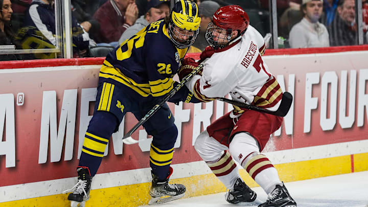 Michigan defenseman Seamus Casey (26) and Boston College defenseman Aidan Hreschuk (7) battle for the puck during the first period of the Frozen Four semifinal game at Xcel Energy Center in St. Paul, Minn. on Thursday, April 11, 2024. Michigan defenseman Seamus Casey (26) and Boston College defenseman Aidan Hreschuk (7) battle for the puck during the first period of the Frozen Four semifinal game at Xcel Energy Center in St. Paul, Minn. on Thursday, April 11, 2024.