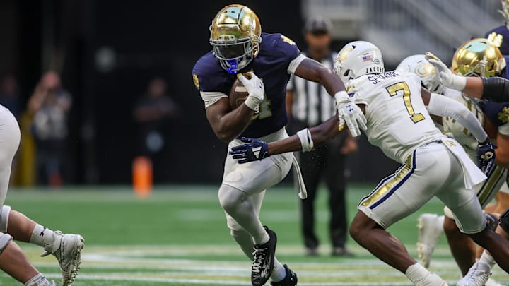 Oct 19, 2024; Atlanta, Georgia, USA; Notre Dame Fighting Irish running back Jeremiyah Love (4) runs the ball against the Georgia Tech Yellow Jackets in the fourth quarter at Mercedes-Benz Stadium. Mandatory Credit: Brett Davis-Imagn Images
