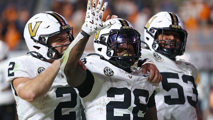 Nov 29, 2025; Knoxville, Tennessee, USA;  Vanderbilt Commodores quarterback Diego Pavia (2), running back Sedrick Alexander (28) and offensive lineman Jordan White (53) celebrate a touchdown against the Tennessee Volunteers during the second half at Neyland Stadium. Mandatory Credit: Randy Sartin-Imagn Images