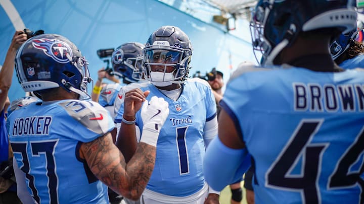 Tennessee Titans quarterback Cam Ward (1), safety Amani Hooker (37) and safety Mike Brown (44)