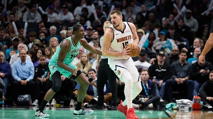 Feb 1, 2025; Charlotte, North Carolina, USA; Denver Nuggets center Nikola Jokic (15) is defended by Charlotte Hornets forward Moussa Diabate (14) during the second half of play at Spectrum Center. Mandatory Credit: Brian Westerholt-Imagn Images