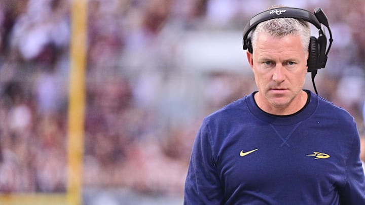 Sep 14, 2024; Starkville, Mississippi, USA; Toledo Rockets head coach Jason Candle walks down the field during the first quarter of the game against the Mississippi State Bulldogs at Davis Wade Stadium at Scott Field. Mandatory Credit: Matt Bush-Imagn Images