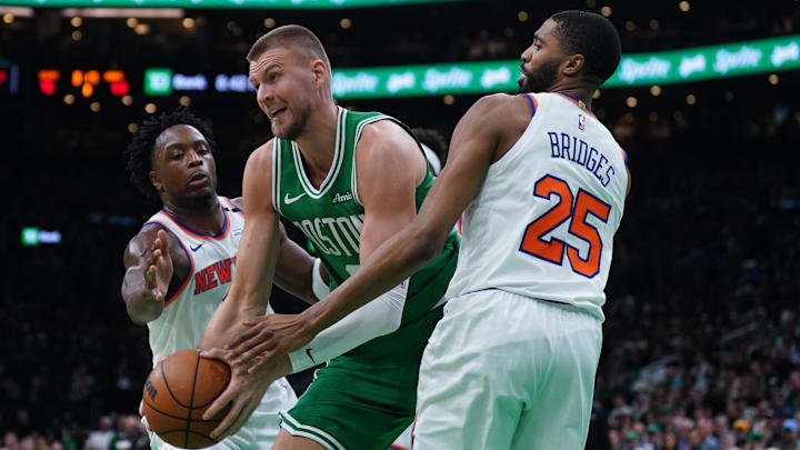 May 7, 2025; Boston, Massachusetts, USA; New York Knicks forward Mikal Bridges (25) and forward OG Anunoby (8) defend against Boston Celtics center Kristaps Porzingis (8) in the second half during game two of the second round for the 2025 NBA Playoffs at TD Garden. Mandatory Credit: David Butler II-Imagn Images