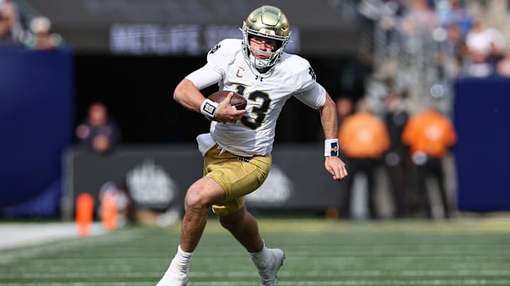 Oct 26, 2024; East Rutherford, New Jersey, USA;Notre Dame Fighting Irish quarterback Riley Leonard (13) carries the ball during the first half against the Navy Midshipmen at MetLife Stadium. Mandatory Credit: Vincent Carchietta-Imagn Images Oct 26, 2024; East Rutherford, New Jersey, USA;Notre Dame Fighting Irish quarterback Riley Leonard (13) carries the ball during the first half against the Navy Midshipmen at MetLife Stadium. Mandatory Credit: Vincent Carchietta-Imagn Images