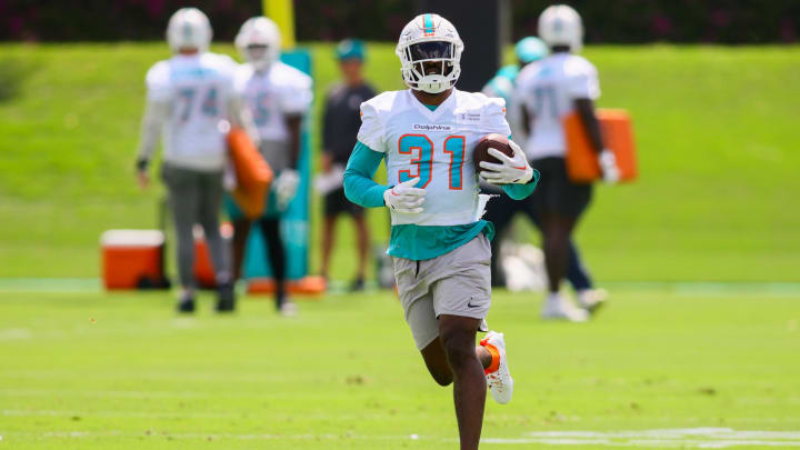Miami Dolphins running back Raheem Mostert (31) runs with the football during mandatory minicamp at the Baptist Health Training Complex in June.
