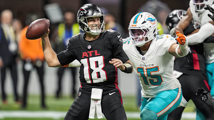 Atlanta Falcons quarterback Kirk Cousins (18) passes under pressure from Miami Dolphins linebacker Jaelan Phillips (15) during the first quarter at Mercedes-Benz Stadium in the 2025 season.