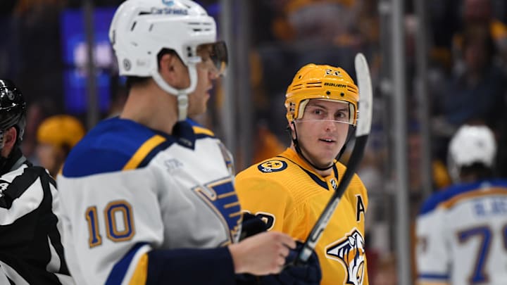 Apr 1, 2023; Nashville, Tennessee, USA; Nashville Predators defenseman Tyson Barrie (22) talks with St. Louis Blues center Brayden Schenn (10) after a play during the first period at Bridgestone Arena. Mandatory Credit: Christopher Hanewinckel-Imagn Images