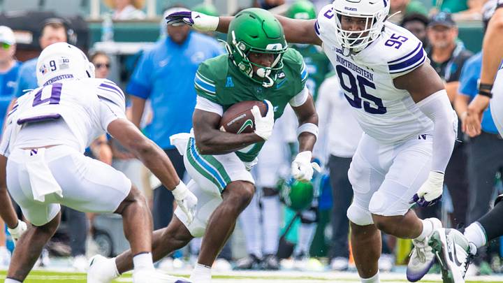 Aug 30, 2025; New Orleans, Louisiana, USA; Tulane Green Wave running back Maurice Turner (0) rushes against Northwestern Wildcats defensive back Braden Turner (9) and defensive lineman Najee Story (95) during the first half at Yulman Stadium. Mandatory Credit: Stephen Lew-Imagn Images Aug 30, 2025; New Orleans, Louisiana, USA; Tulane Green Wave running back Maurice Turner (0) rushes against Northwestern Wildcats defensive back Braden Turner (9) and defensive lineman Najee Story (95) during the first half at Yulman Stadium. Mandatory Credit: Stephen Lew-Imagn Images