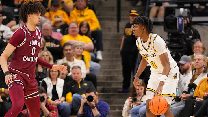 Feb 25, 2025; Columbia, Missouri, USA; Missouri Tigers guard Anthony Robinson II (0) dribbles the ball as South Carolina Gamecocks forward Jordan Butler (0) defends during the second half at Mizzou Arena. Mandatory Credit: Denny Medley-Imagn Images