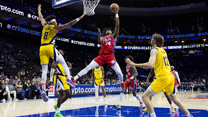 Dec 13, 2024; Philadelphia, Pennsylvania, USA; Philadelphia 76ers guard Ricky Council IV (14) drives for a shot against Indiana Pacers forward Enrique Freeman (8) during the fourth quarter at Wells Fargo Center. Mandatory Credit: Bill Streicher-Imagn Images