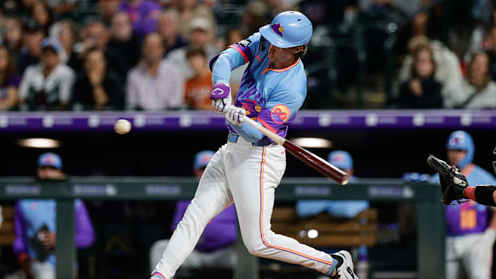 Sep 19, 2025; Denver, Colorado, USA; Colorado Rockies left fielder Mickey Moniak (22) hits a single in the fifth inning against the Los Angeles Angels at Coors Field. 