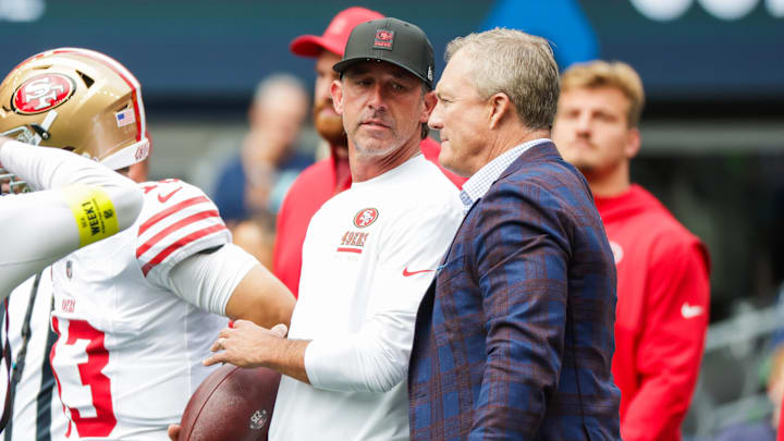 Sep 7, 2025; Seattle, Washington, USA; San Francisco 49ers general manager John Lynch, right, talks with head coach Kyle Shanahan during pregame warmups against the Seattle Seahawks at Lumen Field. Mandatory Credit: Joe Nicholson-Imagn Images