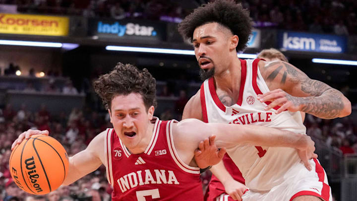 Louisville Cardinals guard J'Vonne Hadley (1) defends Indiana Hoosiers guard Conor Enright (5) during a game Saturday, Dec. 6, 2025, at Gainbridge Fieldhouse in Indianapolis.