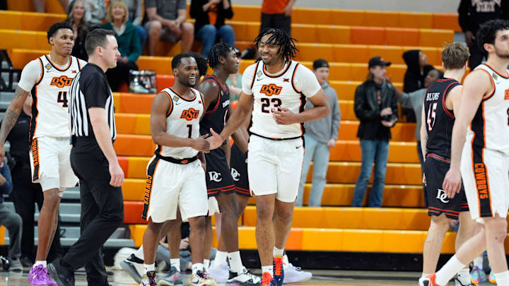 Oklahoma State Cowboys center Benjamin Ahmed (23) celebrates with Oklahoma State Cowboys guard Kanye Clary (1) during a first-round basketball game in the National Invitational between the Oklahoma State Cowboys and the Davidson Wildcats at Gallagher-Iba Arena in Stillwater, Okla., Tuesday, March 17, 2026. Oklahoma State won 84-80. Oklahoma State Cowboys center Benjamin Ahmed (23) celebrates with Oklahoma State Cowboys guard Kanye Clary (1) during a first-round basketball game in the National Invitational between the Oklahoma State Cowboys and the Davidson Wildcats at Gallagher-Iba Arena in Stillwater, Okla., Tuesday, March 17, 2026. Oklahoma State won 84-80.
