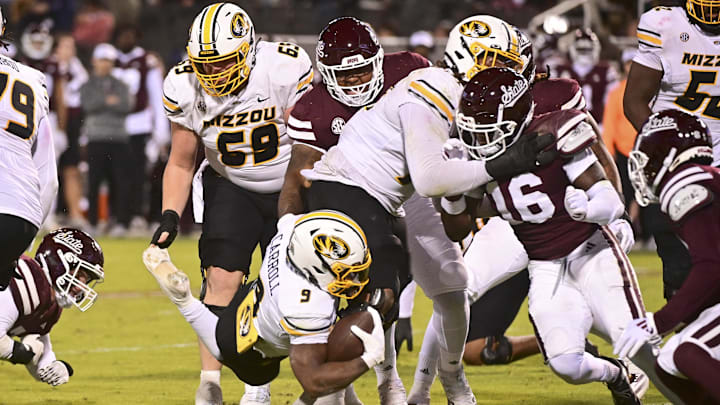 Nov 23, 2024; Starkville, Mississippi, USA; Missouri Tigers running back Marcus Carroll (9) dives for extra yardage against the Mississippi State Bulldogs during the fourth quarter at Davis Wade Stadium at Scott Field. Mandatory Credit: Matt Bush-Imagn Images Nov 23, 2024; Starkville, Mississippi, USA; Missouri Tigers running back Marcus Carroll (9) dives for extra yardage against the Mississippi State Bulldogs during the fourth quarter at Davis Wade Stadium at Scott Field. Mandatory Credit: Matt Bush-Imagn Images