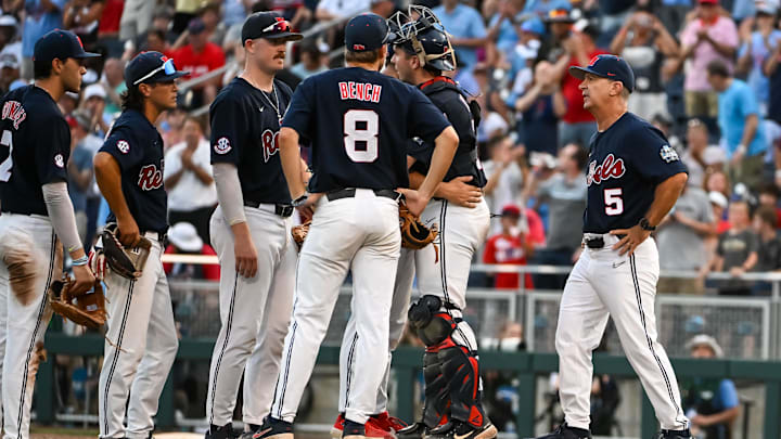 Jun 18, 2022; Omaha, NE, USA;  Ole Miss Rebels head coach Mike Bianco walks to the mound to replace starting pitcher Dylan DeLucia (44) in the eighth inning against the Auburn Tigers at Charles Schwab Field. Mandatory Credit: Steven Branscombe-Imagn Images