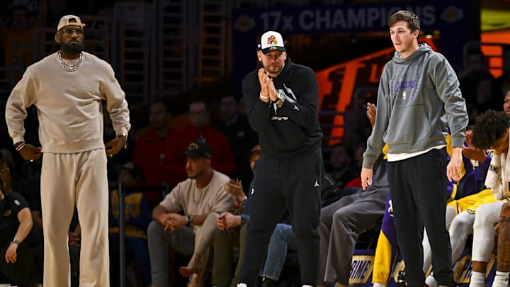 Mar 20, 2025; Los Angeles, California, USA: Los Angeles Lakers forward LeBron James (23), guard Luka Doncic (77), and guard Austin Reaves (15) on the sidelines against the Milwaukee Bucks during the first half at Crypto.com Arena. Mandatory Credit: Jonathan Hui-Imagn Images Mar 20, 2025; Los Angeles, California, USA: Los Angeles Lakers forward LeBron James (23), guard Luka Doncic (77), and guard Austin Reaves (15) on the sidelines against the Milwaukee Bucks during the first half at Crypto.com Arena. Mandatory Credit: Jonathan Hui-Imagn Images