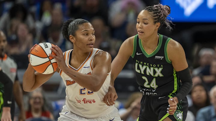 Phoenix Mercury forward Alyssa Thomas (25) holds the ball as Minnesota Lynx forward Napheesa Collier (24) plays defense in the first half during game one of the second round for the 2025 WNBA Playoffs at Target Center. 